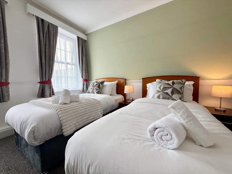 Relax in our spacious Triple Room, ideal for up to three guests. It offers three single beds, a private bathroom, Smart TV, fast Wi-Fi and tea and coffee facilities. Room layouts and décor may vary.