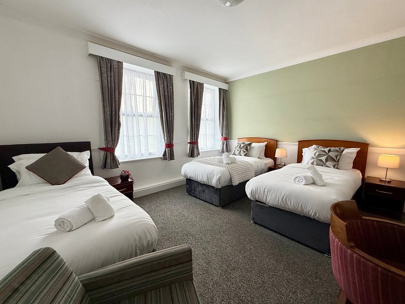 Relax in our Family Triple Room, ideal for up to three guests. It offers one double and one single bed, a private bathroom, Smart TV, fast Wi-Fi and tea and coffee facilities. Rooms may vary.