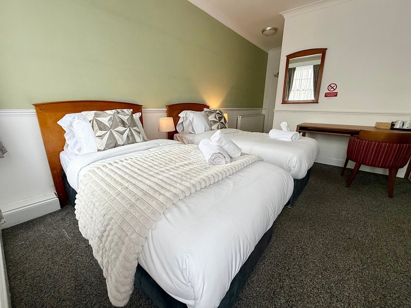 Relax in our Family Triple Room, ideal for up to three guests. It offers one double and one single bed, a private bathroom, Smart TV, fast Wi-Fi and tea and coffee facilities. Rooms may vary.