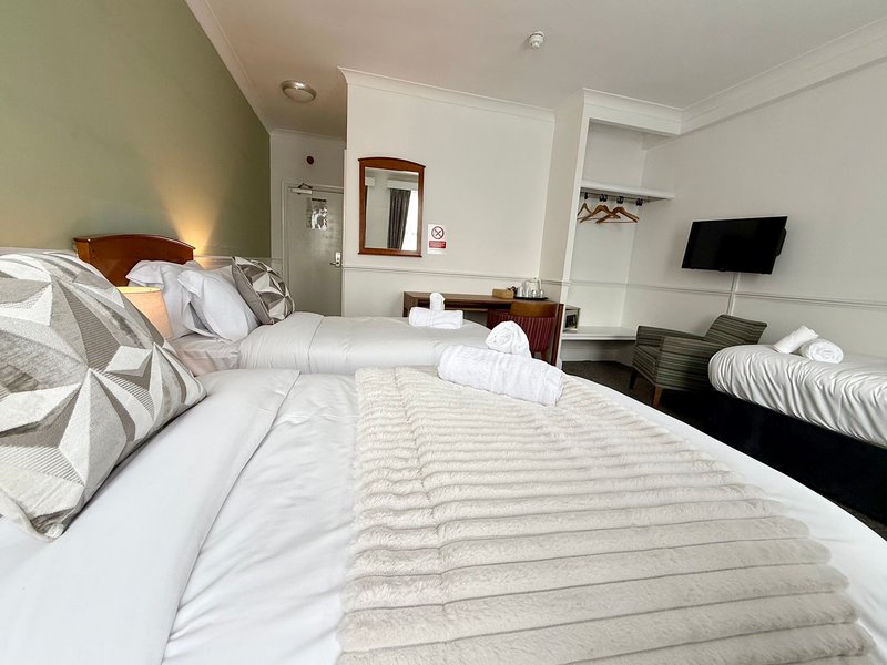 Relax in our Family Triple Room, ideal for up to three guests. It offers one double and one single bed, a private bathroom, Smart TV, fast Wi-Fi and tea and coffee facilities. Rooms may vary.
