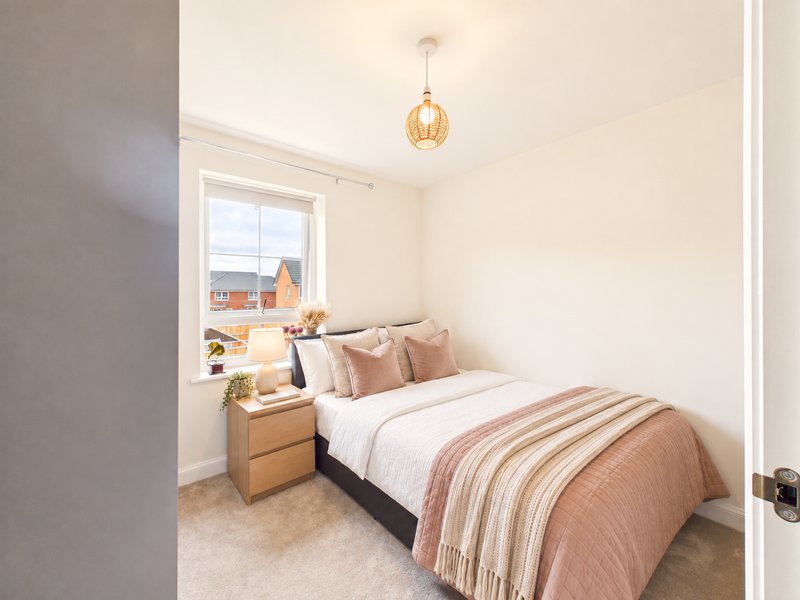 Bedroom with double bed, striped bedding, wooden bedside table, pendant light, and window with city view