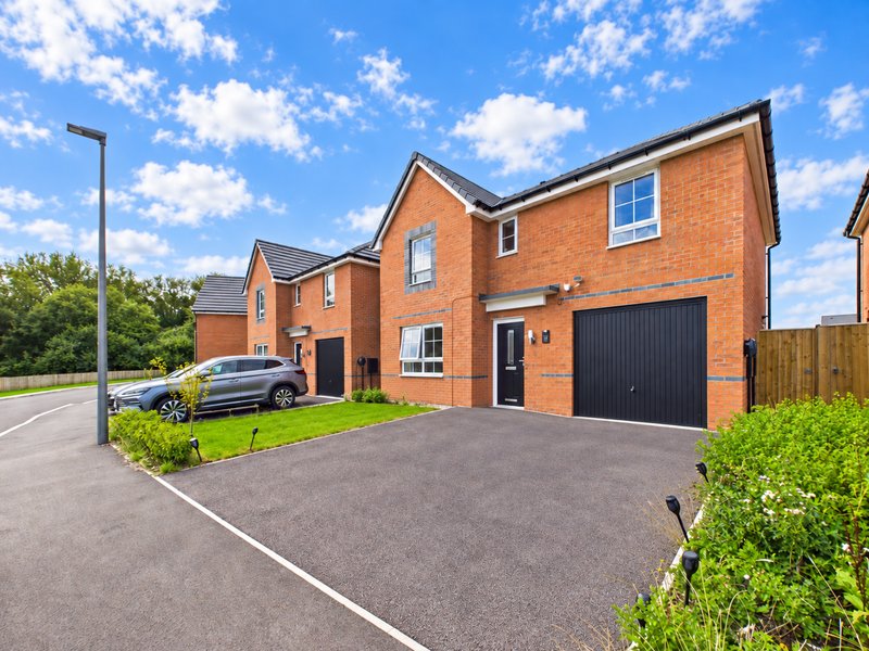Modern brick detached house with driveway, garage and parked car
