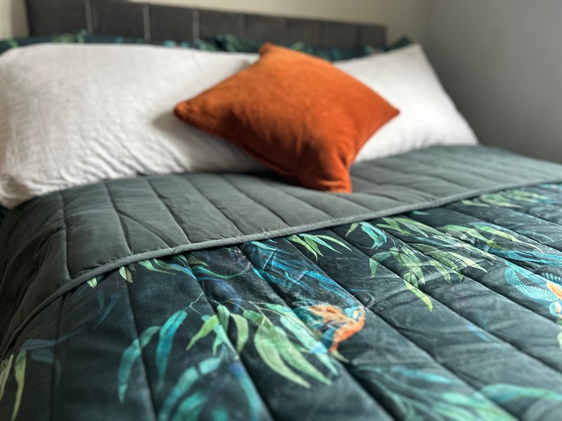Small double bed, hanging space and side cabinet.