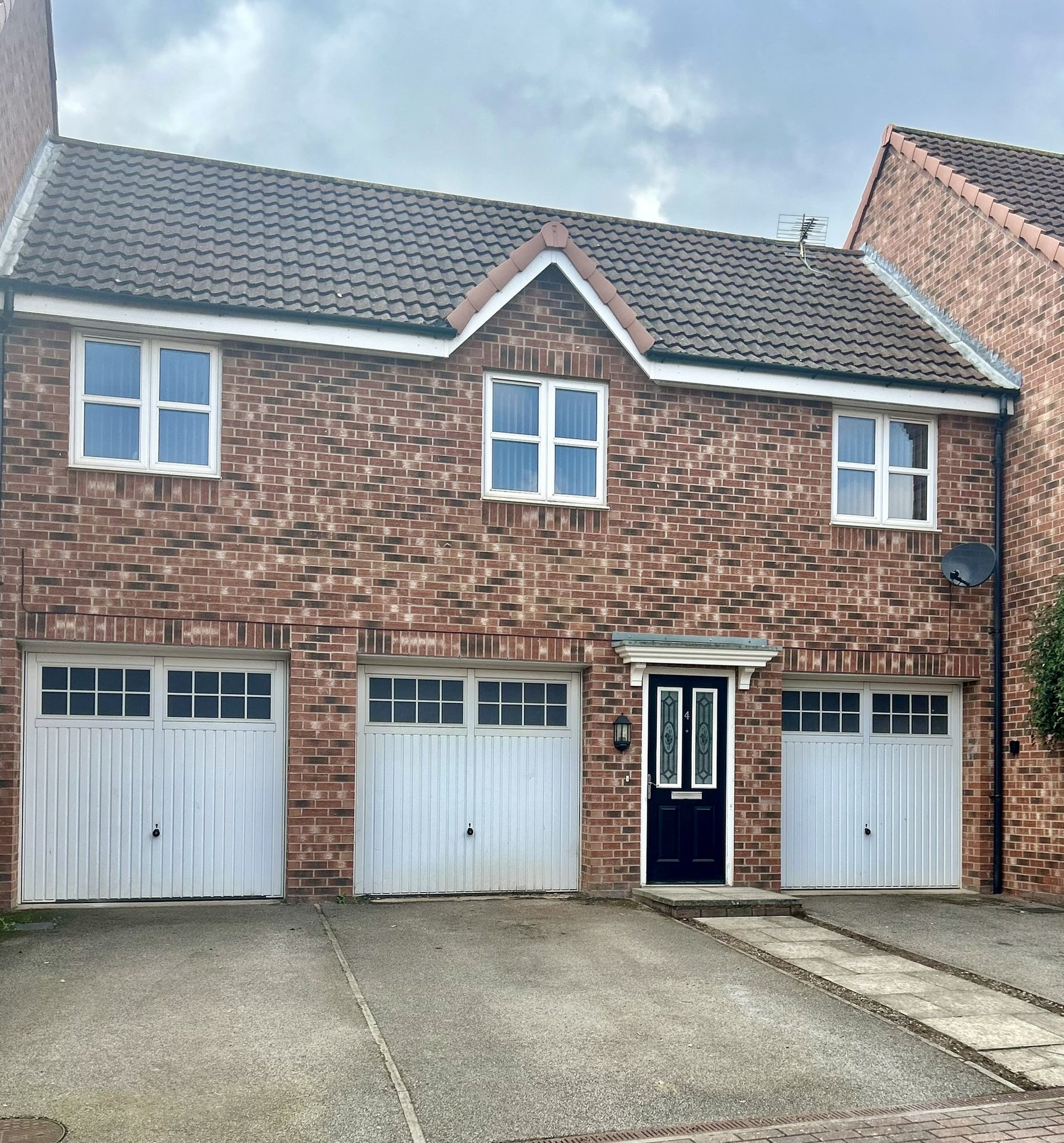 Brick residential property with private entrance, garage & parking space.