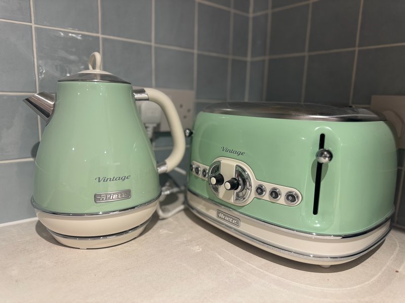 Vintage-style mint green kettle and toaster on kitchen counter