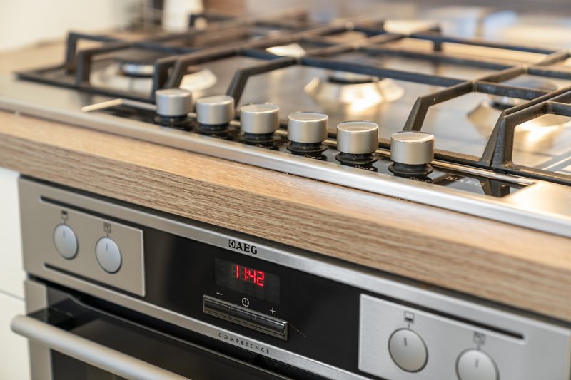 Close-up of modern gas cooker with stainless steel finish and control knobs