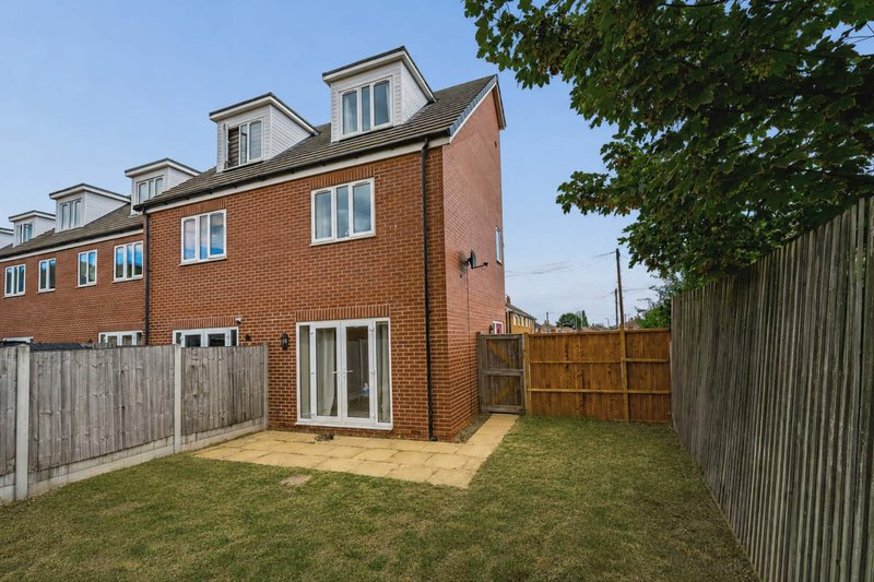 Modern brick semi-detached house with garden, patio area and wooden fencing