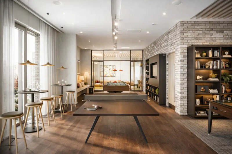 Modern open-plan living space with dining area, workspace, brick fireplace and wooden flooring