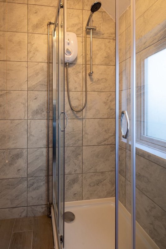 Bathroom with walk-in shower enclosure, tiled walls, rainfall showerhead and handheld spray