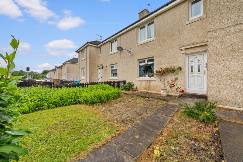 Terraced house exterior with front garden, pathway, and neighboring properties visible