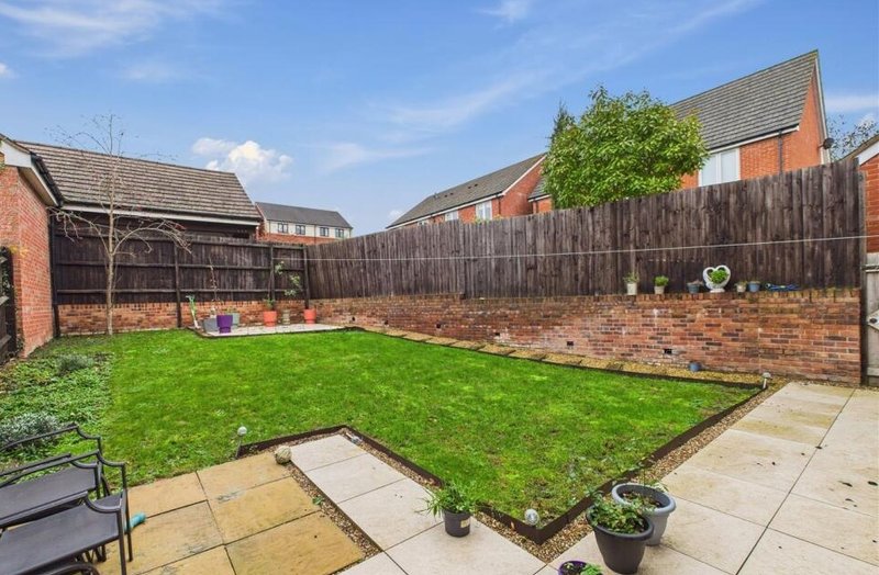 Rear garden with lawn, patio area and wooden fence