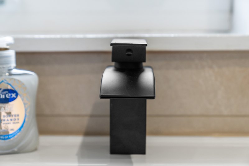Bathroom sink counter with soap dispenser, faucet and toiletries