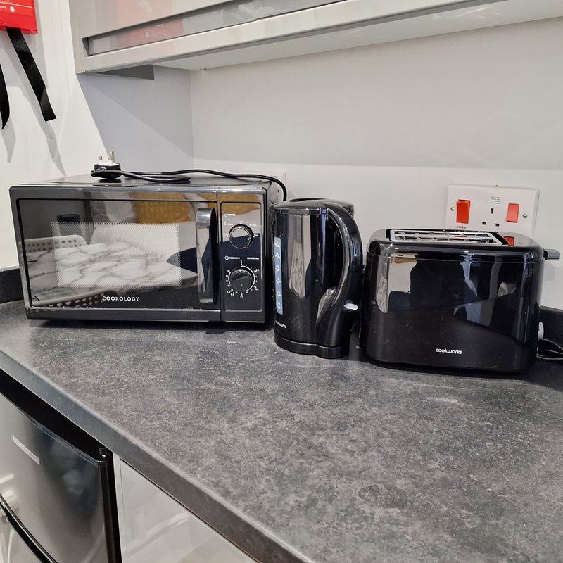 Kitchen countertop with microwave, kettle, and small appliances