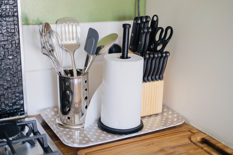 Kitchen counter with utensil holders, paper towel dispenser, and knife block
