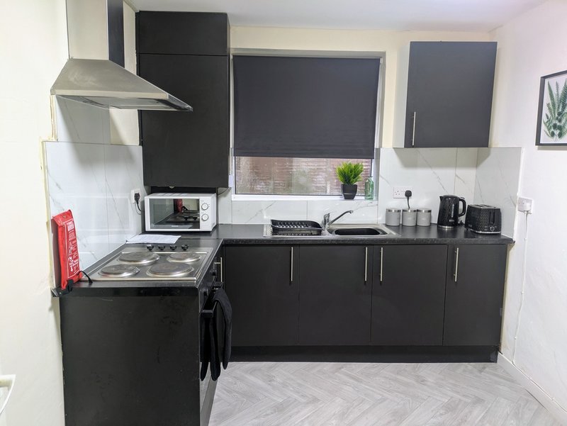 Generous worktop space makes preparing meals straightforward, while ample cupboard storage keeps the kitchen organised. A great setup for crews working away, with everything you need to cook and eat