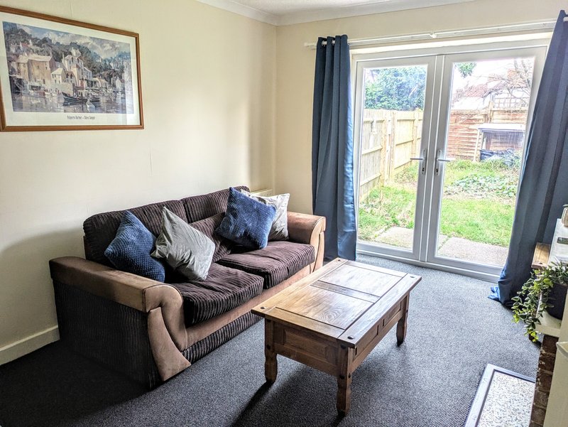 Comfortable living room with a sofa and coffee table, providing working groups with a welcoming space to relax and unwind after a busy day.