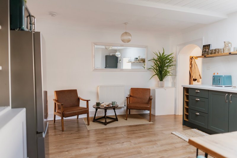 The open-plan kitchen/diner has the added bonus of an additional two armchairs which is a lovely relaxing area