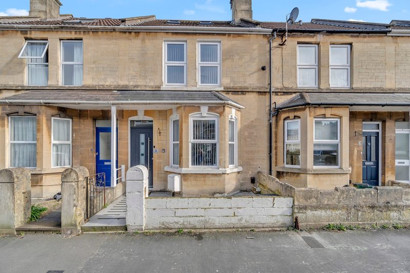Terraced stone houses with blue doors, front gardens and period windows
