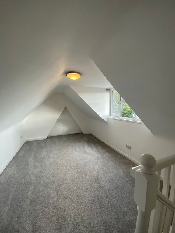 Bright attic room with sloped ceiling, recessed lighting, carpet flooring and small window