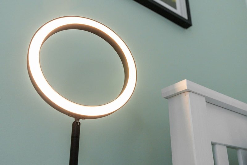 Bathroom interior with circular illuminated mirror and white door frame