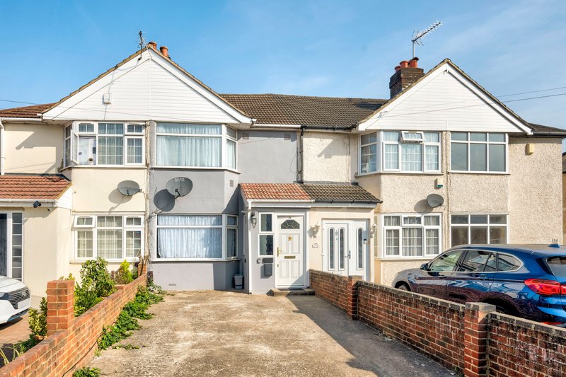 Cream-coloured terraced houses with bay windows, brick walls, satellite dishes, and parked cars on driveway