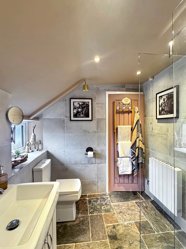 Modern bathroom with double vanity, toilet, walk-in shower and heated towel rail