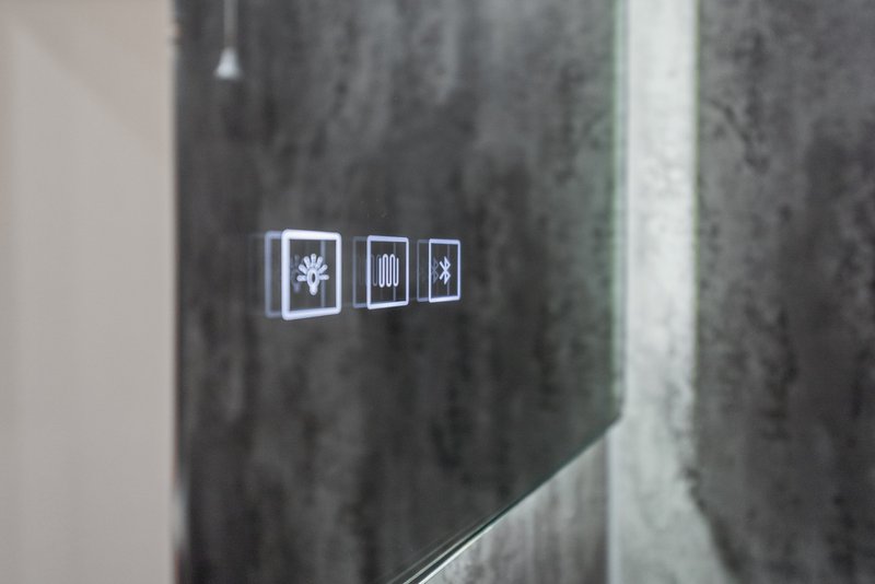 Three small framed minimalist art prints mounted on concrete wall