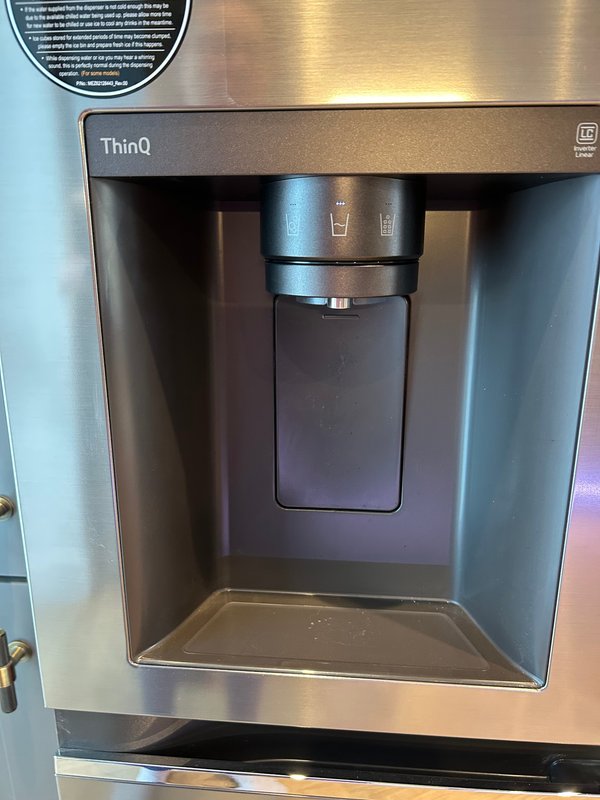Stainless steel refrigerator with water and ice dispenser in kitchen
