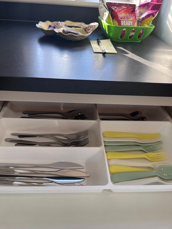 Kitchen drawer organizer with cutlery, utensils, and colorful kitchen tools neatly arranged
