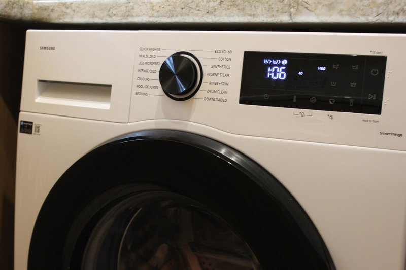 White front-loading washing machine with digital display and control panel