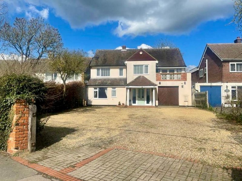 Two-storey detached house with driveway, front garden and neighbouring properties visible