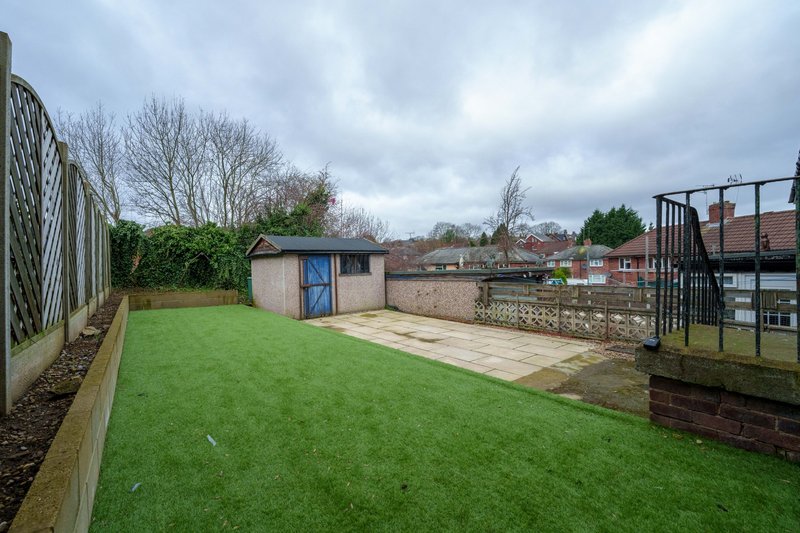 Spacious garden with lawn, patio area, shed and metal fencing
