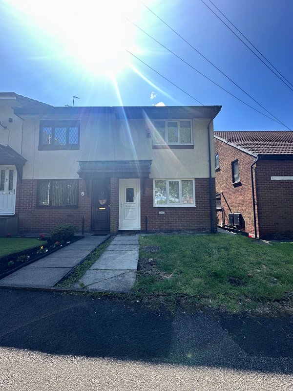 Semi-detached house with brick and render facade, front garden, driveway and garage