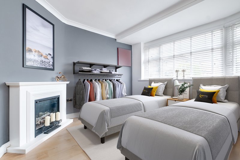 Modern bedroom with three beds, fireplace, clothing rack, and large windows with shutters