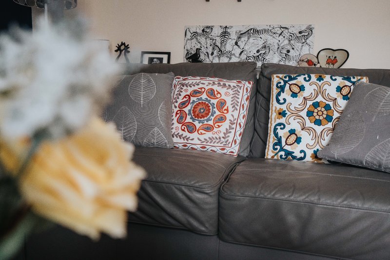 Gray sofa with decorative cushions and wall art in living room