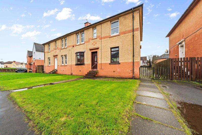Red brick semi-detached house with front garden, driveway and neighboring properties visible
