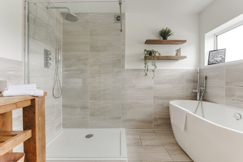 Modern bathroom with walk-in shower, freestanding bathtub, wooden vanity and shelving