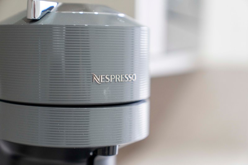 Gray Nespresso coffee machine on kitchen counter with blurred background