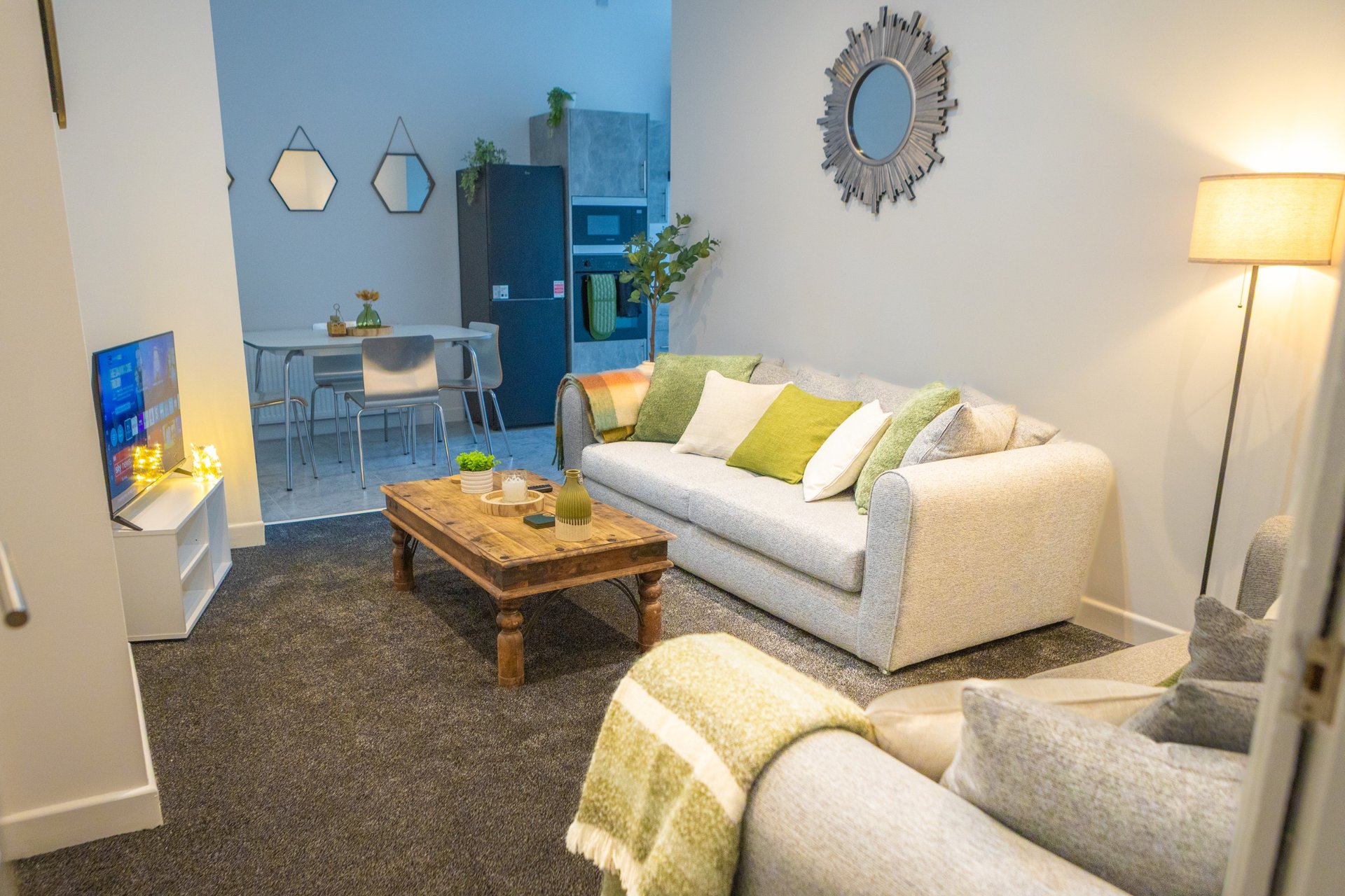 Modern living room with cream sofa, wooden coffee table, decorative cushions and floor lamp