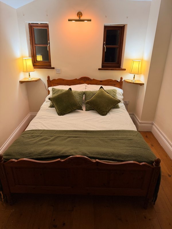 Bedroom with four-poster bed, private bathroom separate seating area, tv, fridge, tea and coffee facilities, large ensuite bathroom with walk in shower and roll top bath, private enclosed garden