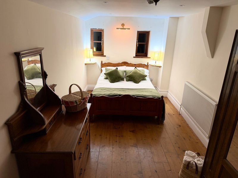 Bedroom with double bed,Bedroom private bathroom separate seating area, tv, fridge, tea and coffee facilities, large ensuite bathroom with shower