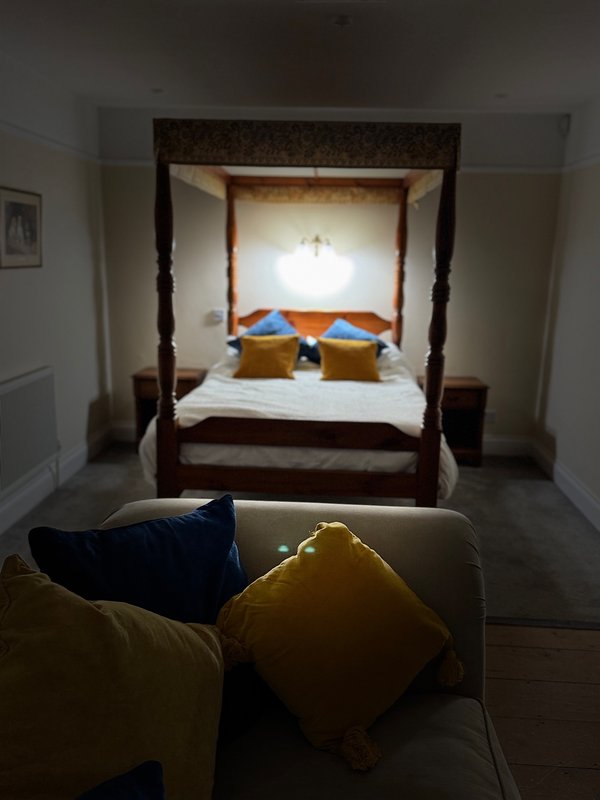 Bedroom with double and a single bed,separate seating area, tv, fridge, tea and coffee facilities, large ensuite bathroom with walk in shower and roll top bath, private enclosed garden