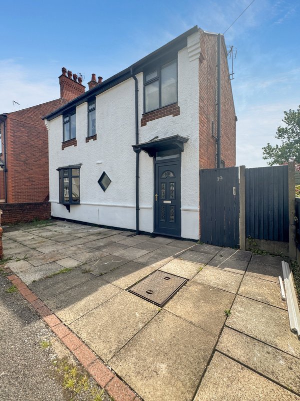 Traditional semi-detached house with brick and white render, dark blue door and black gate