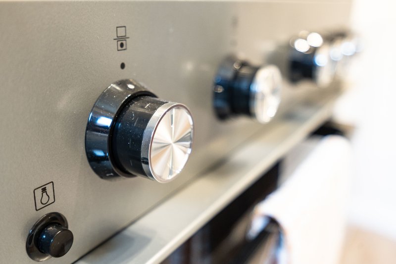 Close-up of audio equipment control panel with knobs and switches