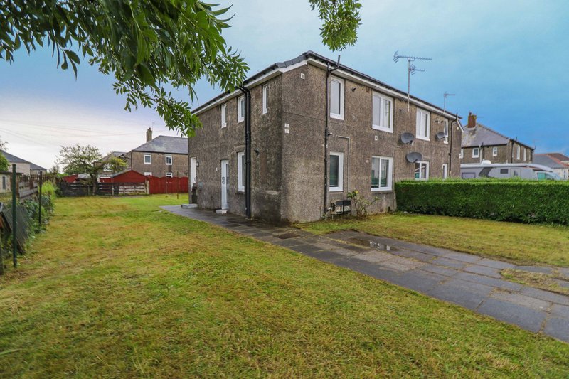 Stone semi-detached house with driveway, front garden and neighboring properties