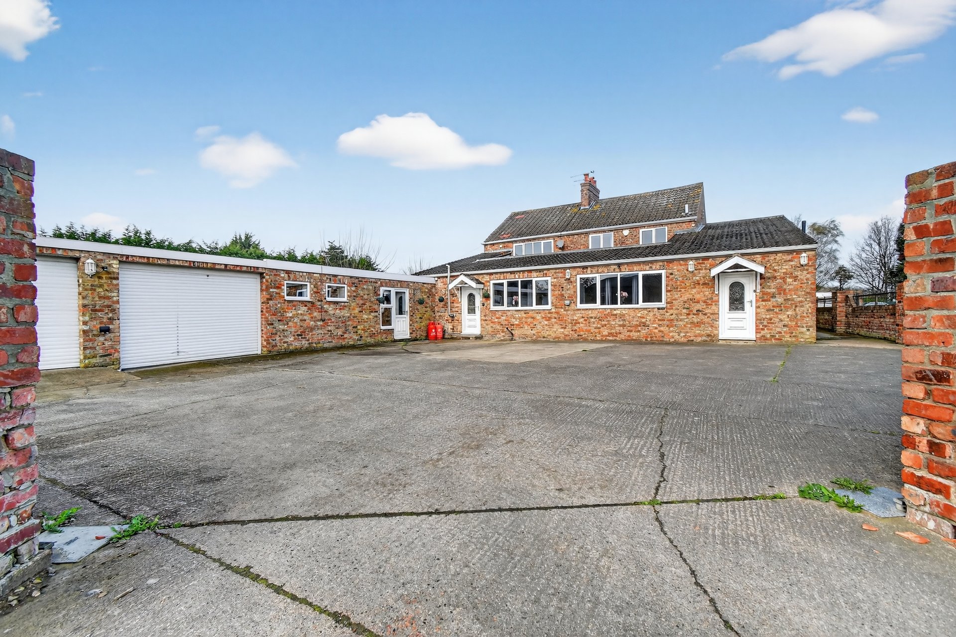 Brick bungalow with driveway, garage, and residential street frontage