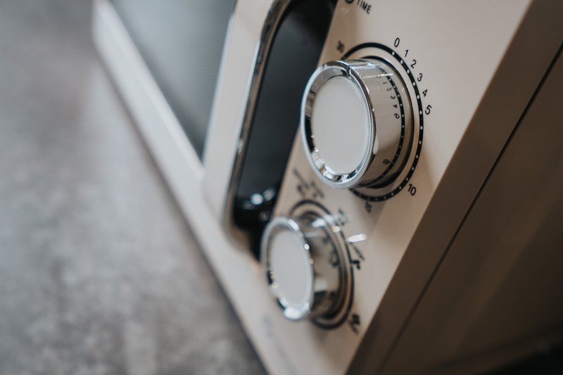 Close-up of washing machine control panel with temperature and cycle dials