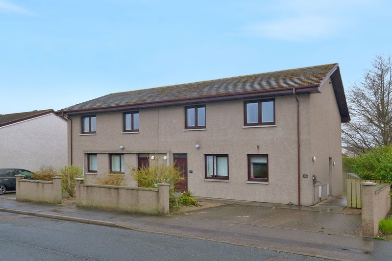 Two-storey detached house with rendered walls, driveway and front garden