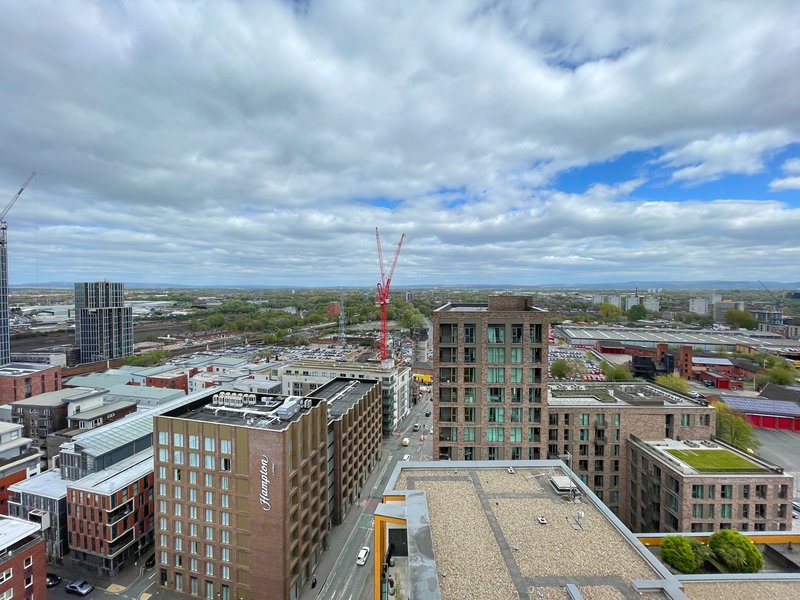 Urban cityscape aerial view with modern residential and commercial buildings under cloudy sky