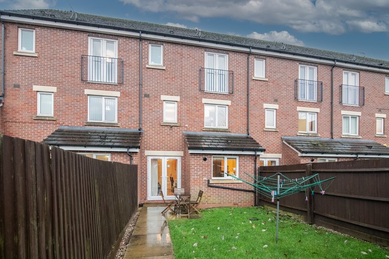 Brick townhouse with garden, patio doors, clothesline and wooden fencing